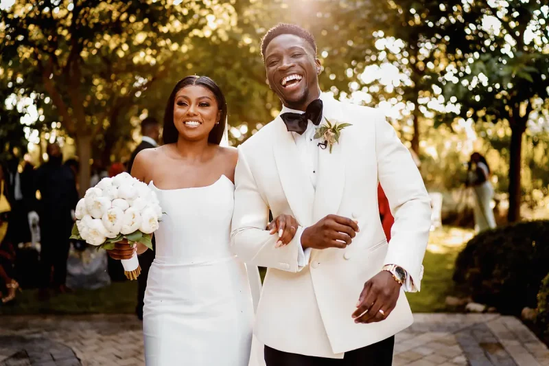 Happy bride and groom exiting their wedding ceremony in France by destination wedding photographer Oben Studio®