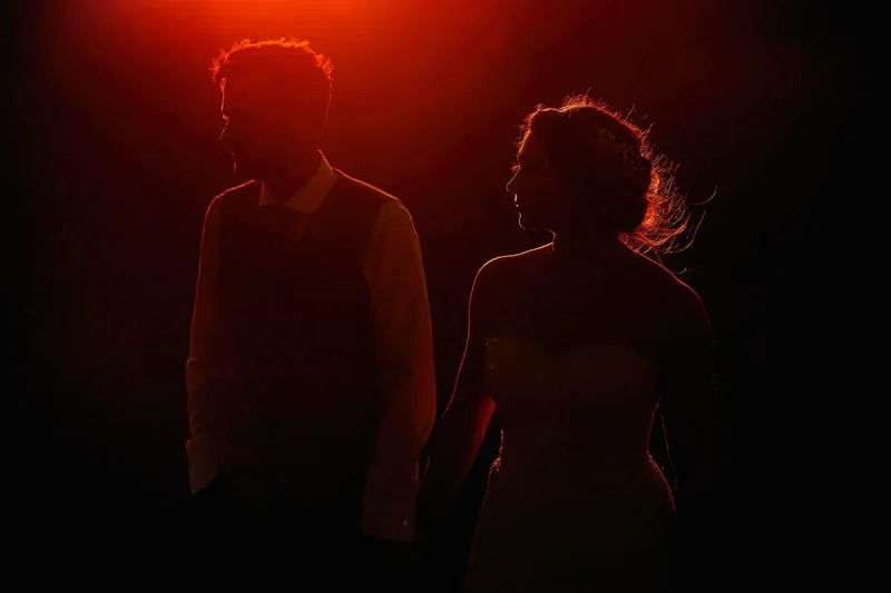 A dark and moody sunset wedding photo - artistic wedding photography by Oben Studio®